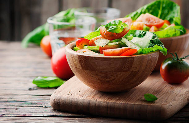 Concept of healthy food: salad with tomato and cucumber, selective focus